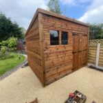 Medium tantalised shed with a double door and two side windows