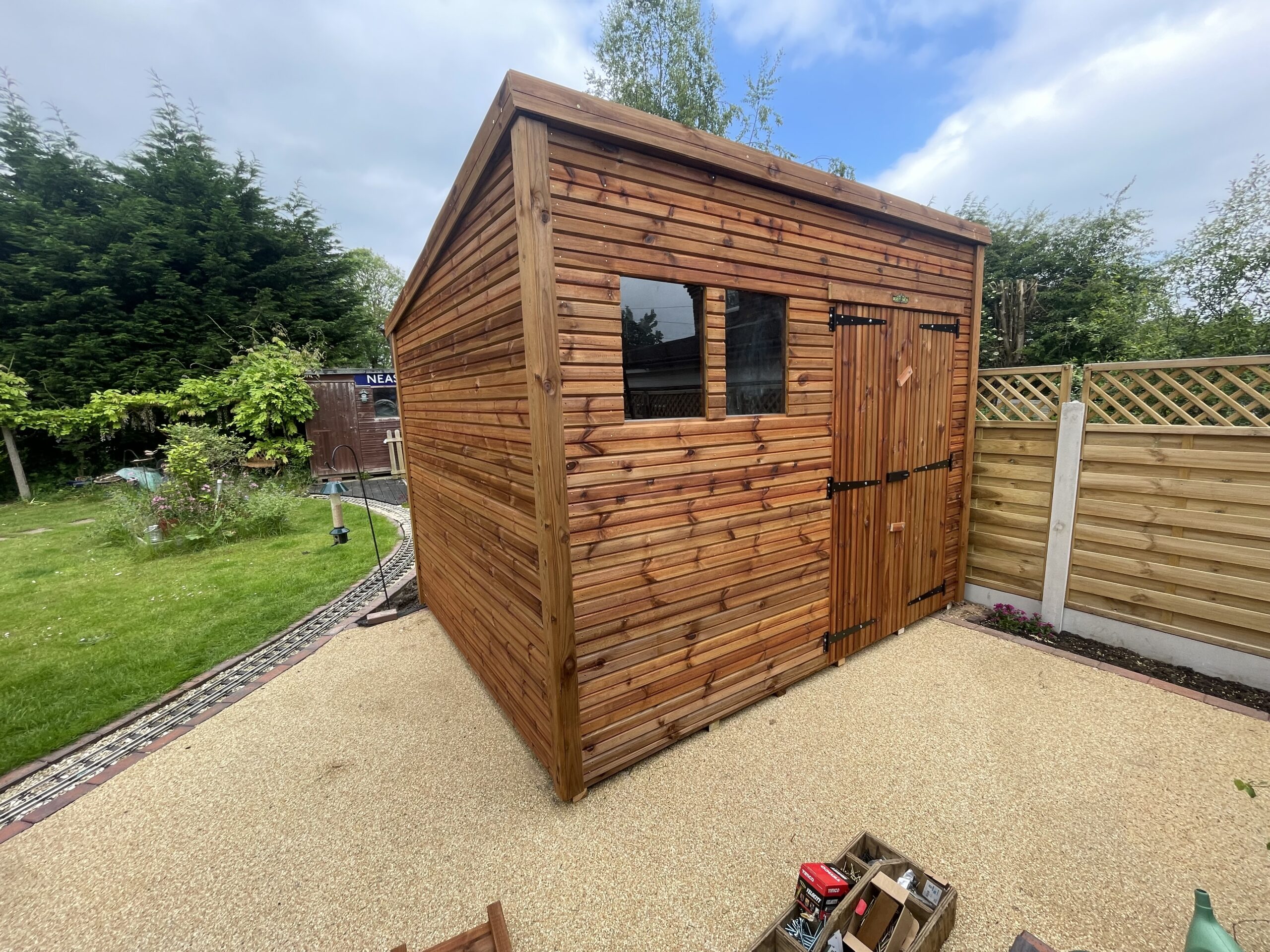 Medium tantalised shed with a double door and two side windows