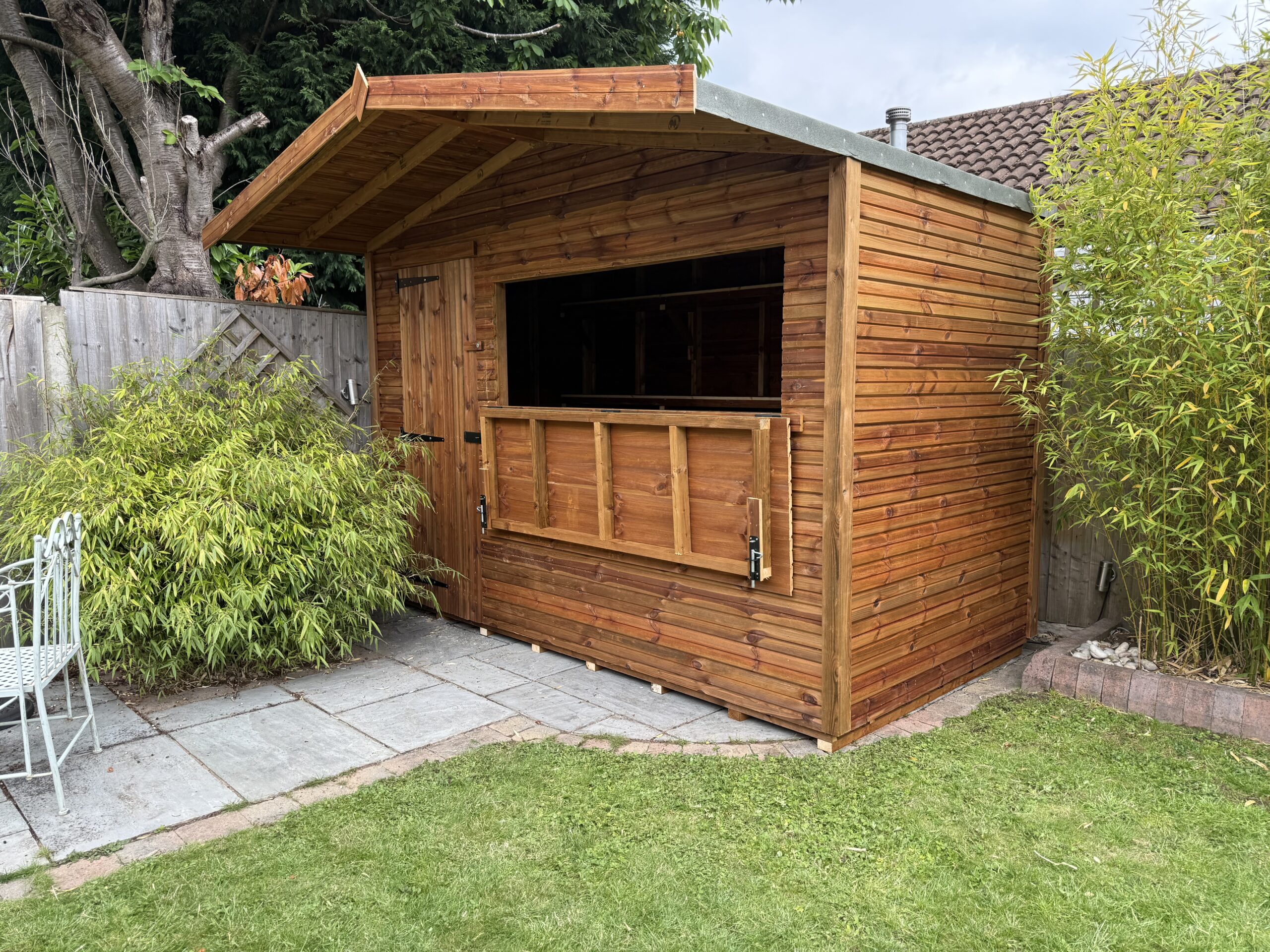 Timber bar shed with an overhang on concrete base