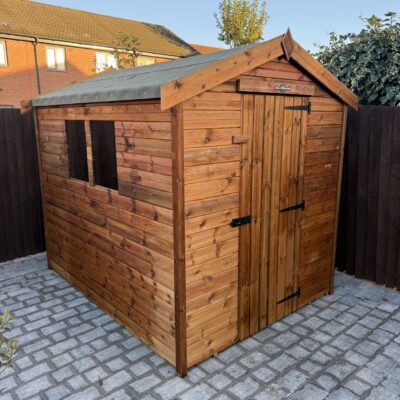 Pressure-treated wooden pent shed with single door and side window, suitable for compact garden storage.