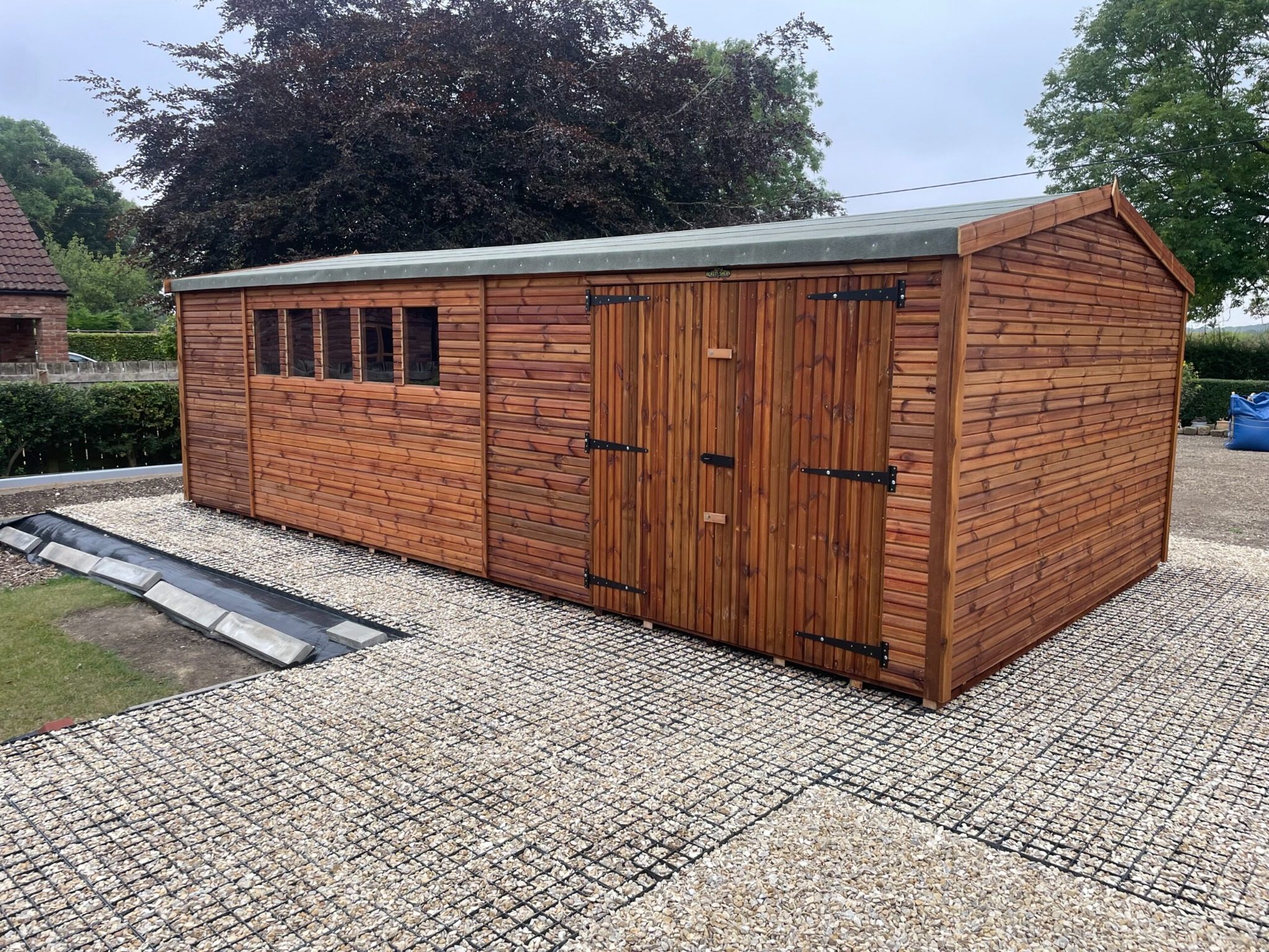 Large wooden shed with weatherproof treatment