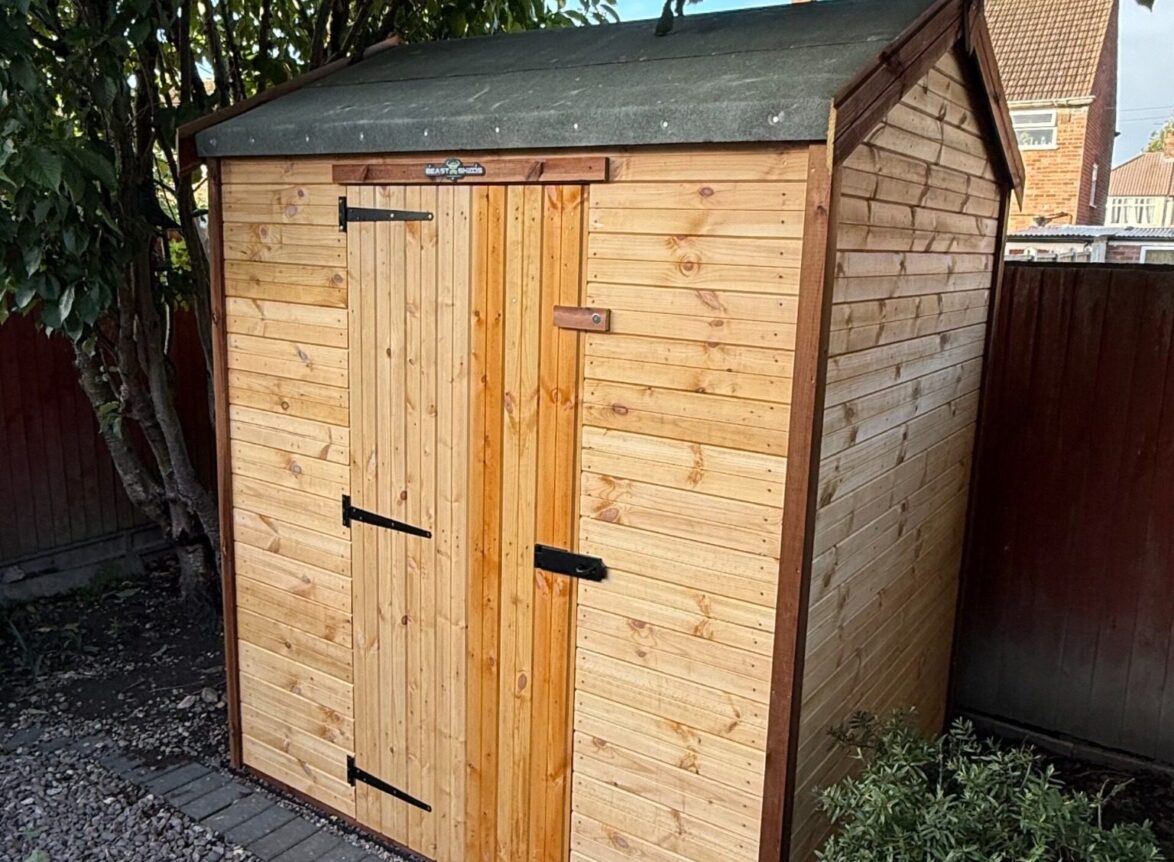 small apex standard wooden garden shed with a single door