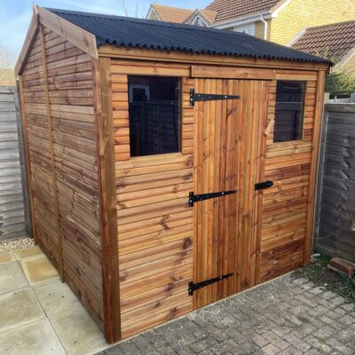 Small apex shed with onduline roofing and a single door