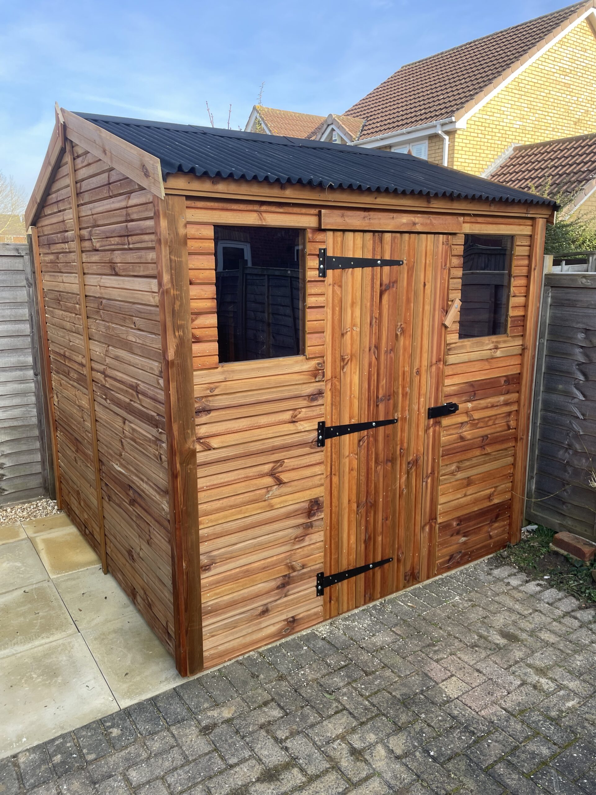 Small apex shed with onduline roofing and a single door
