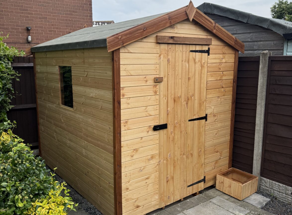 Timber garden shed shown from side angle, featuring shiplap cladding, felt roof, and secure door hinges.