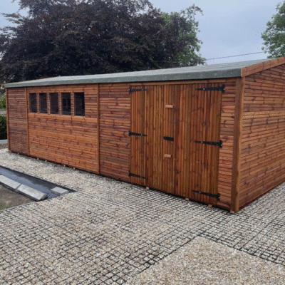 A large apex garden shed with 5 windows and a double door